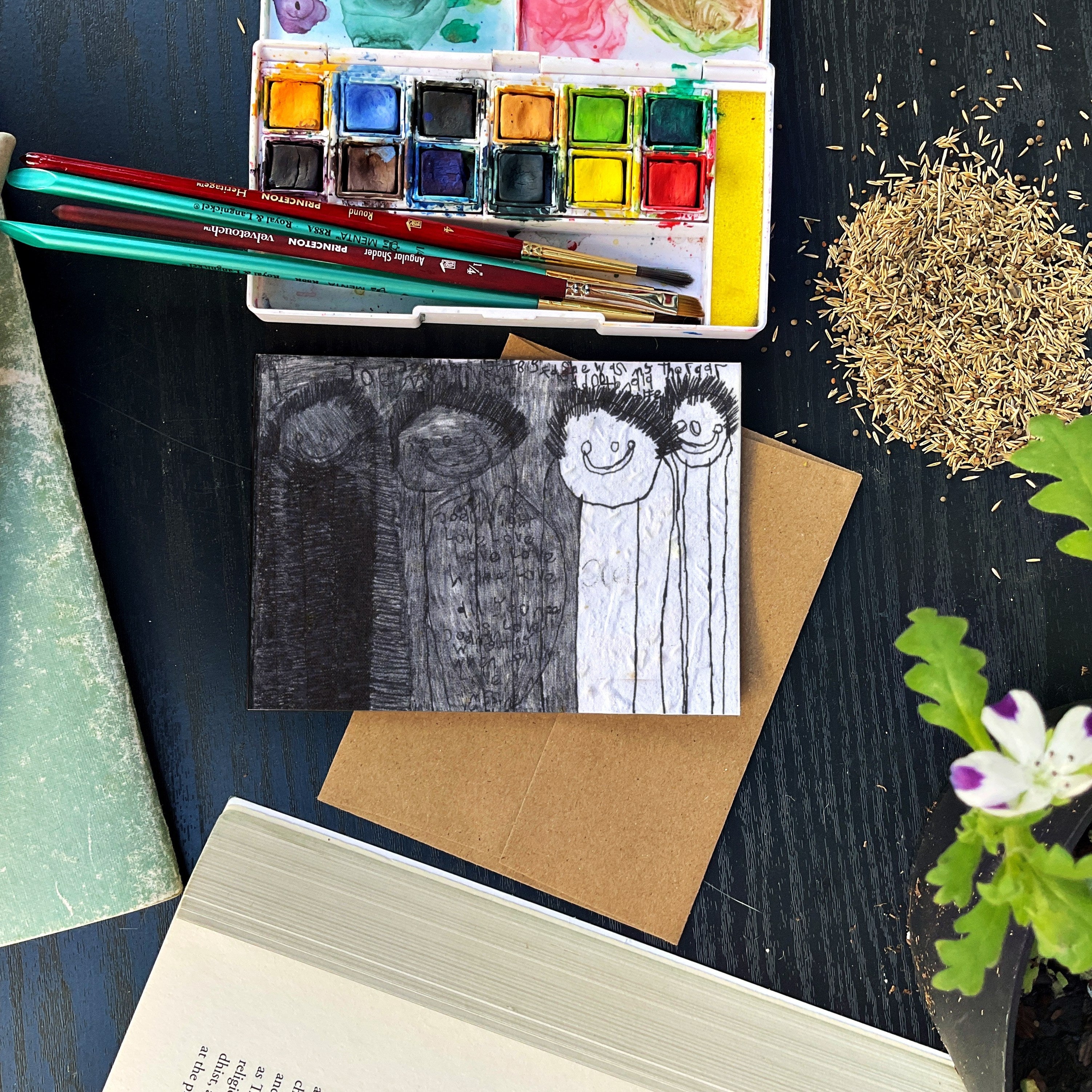 A greeting card with stick figures and shades of grey and white.